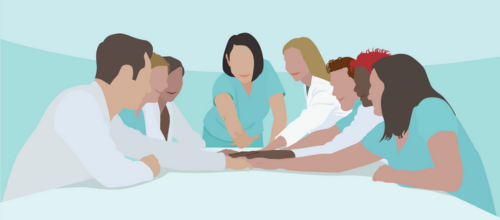A team of clinicians with their hands together in a meeting